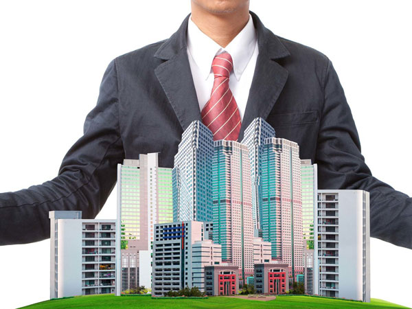 Man standing behind small city buildings
